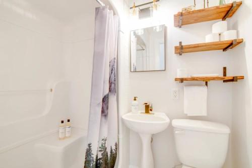 a white bathroom with a toilet and a sink at NN - The Den - Riverdale 1-bed 1-bath in Whitehorse