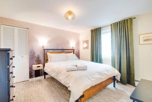a bedroom with a large bed and a window at NN - The Den - Riverdale 1-bed 1-bath in Whitehorse