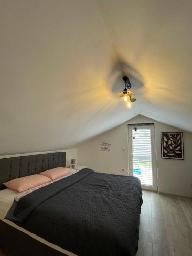 a bedroom with a bed and a ceiling fan at Villa Ana in Posedarje
