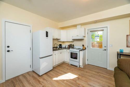a kitchen with white cabinets and a white refrigerator at NN The Lavendar B Whistlebend 1bed 1bath in Whitehorse