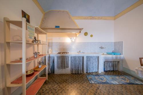 a kitchen with a sink and a counter at Antica Dimora Leones in Palaia