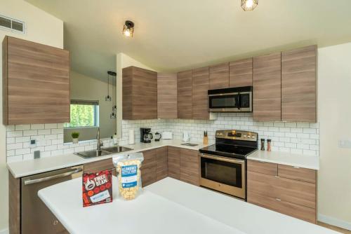 a kitchen with wooden cabinets and a stove top oven at NN - The Lavendar A - Whistlebend 2-bed 1-bath in Whitehorse