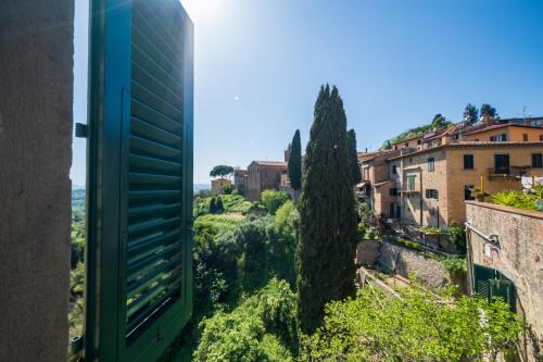 a view from the window of a building with a tree at Antica Dimora Leones in Palaia