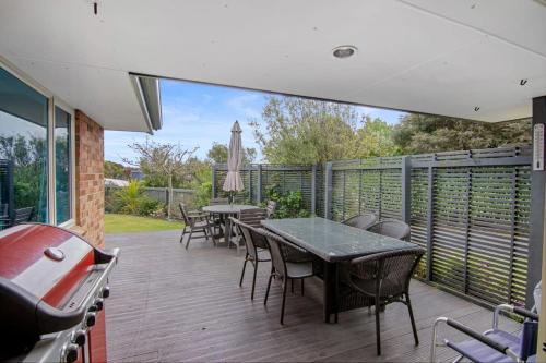 a patio with a table and chairs and a grill at Pohara Beach Life in Pohara