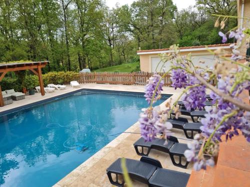una piscina con tumbonas junto a una casa en Appartement de 3 chambres avec piscine partagee jardin clos et wifi a Maurens, en Maurens