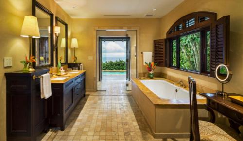 a large bathroom with a tub and a sink at Royal Isabela in Isabela