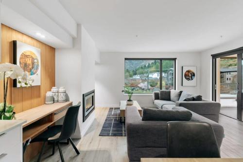 a living room with a couch and a table at Coronet Base at La Residence du Parc in Queenstown