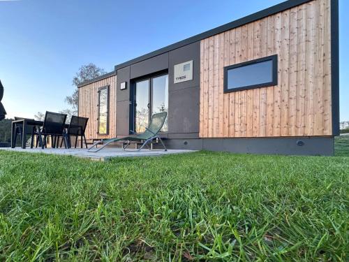 a house with a green lawn in front of it at tiny house am See, Neunburg vorm Wald in Neunburg vorm Wald