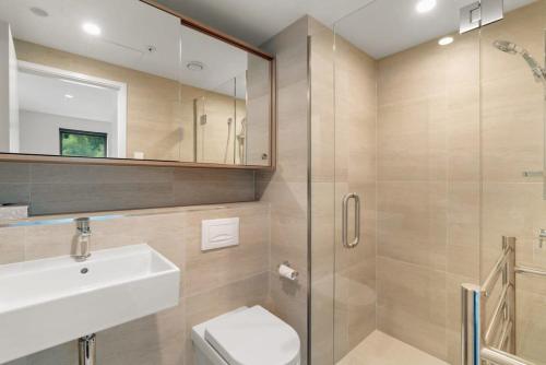 y baño con aseo, lavabo y ducha. en Vue Alpine - La Residence du Parc, en Queenstown