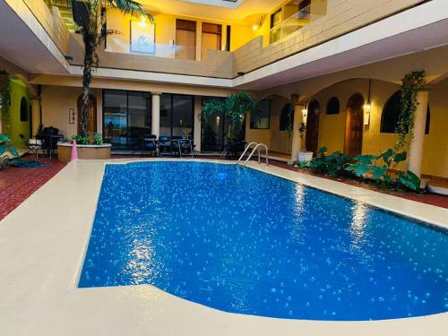 a large blue swimming pool in a building at Hotel VSI in Playa del Carmen