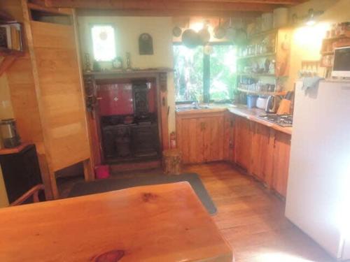 a kitchen with a table and a refrigerator at The Hub in Collingwood