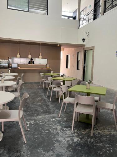 a restaurant with tables and chairs in a room at Aura Hotel B&B in Guadalajara