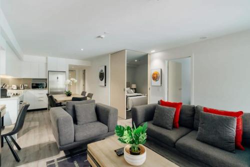 a living room with a couch and a table at Penthouse Leisure in Queenstown