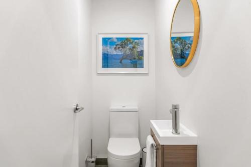 a bathroom with a white toilet and a mirror at The 1 With The View in Albert Town