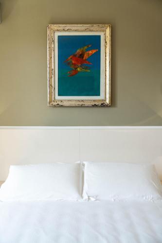 a picture of a bird flying above a bed at Le camere sui colli in La Spezia