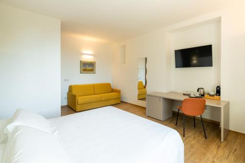 a hotel room with a bed and a desk and a couch at Le camere sui colli in La Spezia