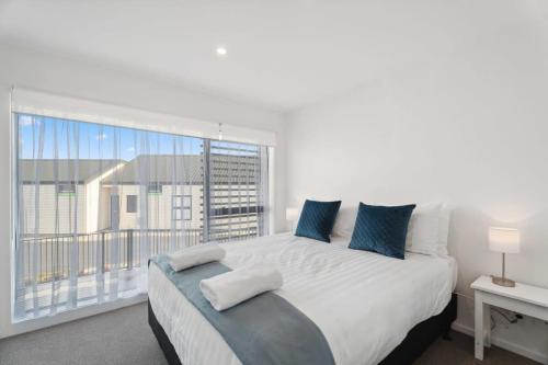 a bedroom with a large bed and a large window at Rivers Edge - Alberttown in Albert Town