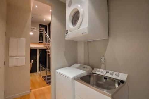 a small kitchen with a sink and a microwave at Mataraki Magic in Wanaka