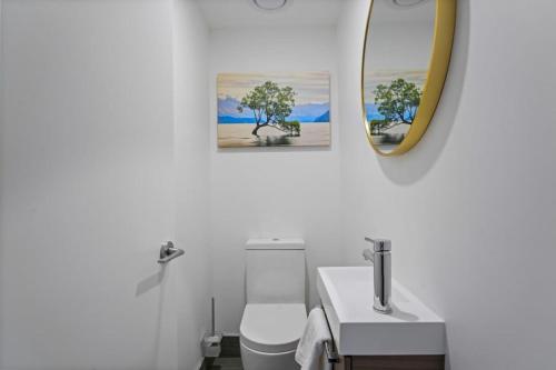 a bathroom with a sink and a mirror and a toilet at Maude View in Albert Town