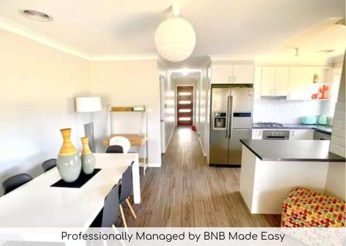 a kitchen and living room with a kitchen and a living room at Modern Majestic - Everything you need Neat & Tidy in Orange