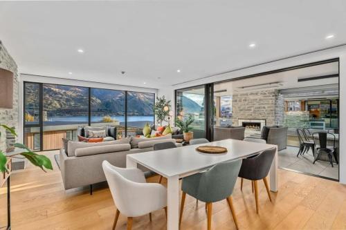 a living room with a couch and a table and chairs at Lakeview Luxury Vista in Wanaka