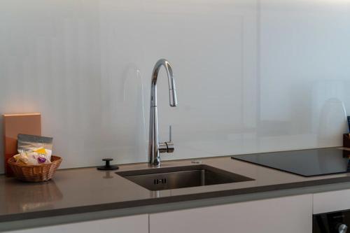 a kitchen with a sink and a counter top at Alps and Lake Retreat Wanaka in Albert Town