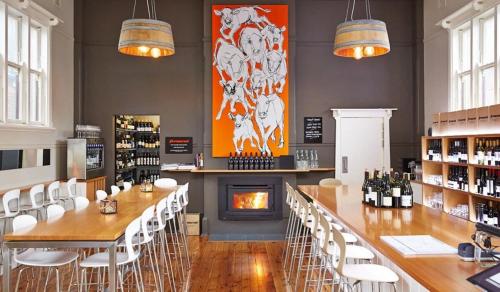 a room with a fireplace and a long table and chairs at Cadogan House - Professionally Styled in CBD in Orange