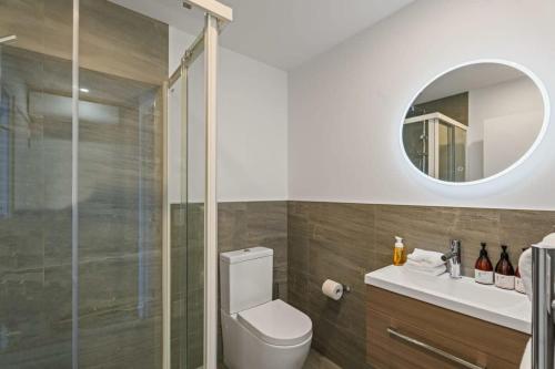 a bathroom with a toilet and a sink and a mirror at Rivers Abode in Albert Town