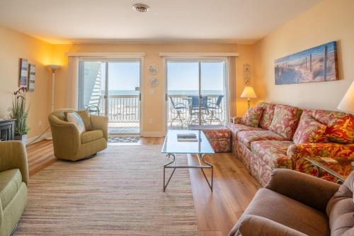 a living room with a couch and chairs at Oceanfront Condo with 3+ Pools - Ocean Dunes 2003 in Kure Beach