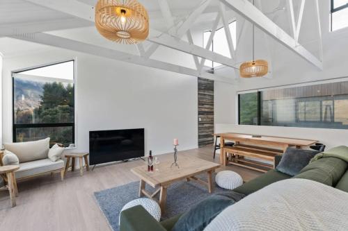 a living room with a couch and a table at Chateau Shotover in Queenstown