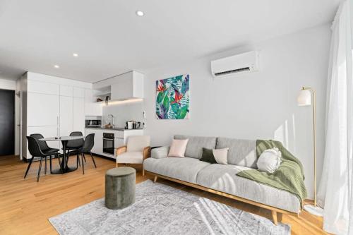a living room with a couch and a table at Alpine Adventurer's Abode in Albert Town