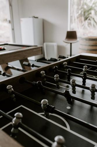 a row of black tables in a room with a lamp at Dovecote: 5-bedroom Home with Hot tub & Games room in Arrowtown