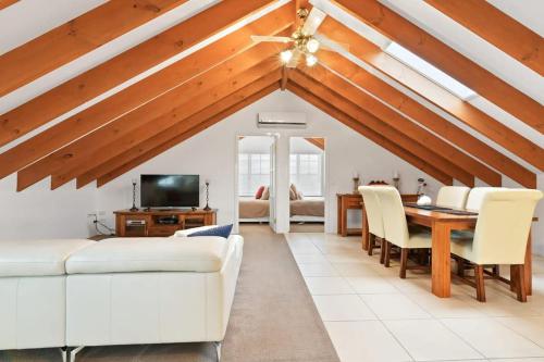a living room with a white couch and a table at Peel St - Walk to CBD, Large Family Home in Bathurst