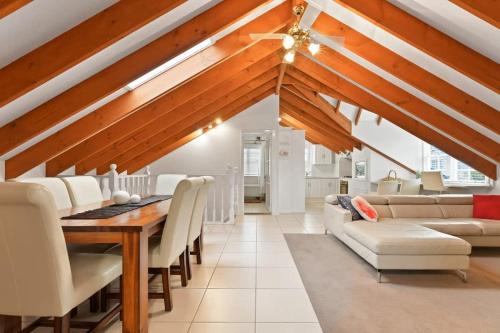 a living room with a dining table and a couch at Peel St - Walk to CBD, Large Family Home in Bathurst