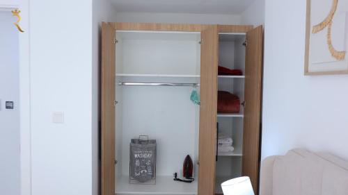 a sliding glass door in a room at Ivory Haven - Stylish 1BR Apartment in Oasis, Tranquil Stay Near Masdar Park in Abu Dhabi