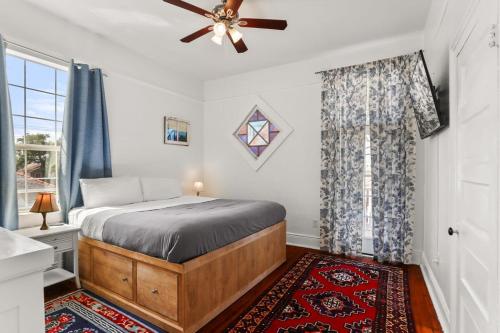 a bedroom with a bed and a ceiling fan at Beautiful Historic Mid City Home in New Orleans