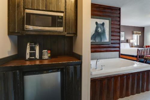 a kitchen with a bath tub and a microwave at Stoney Creek Hotel Tulsa - Broken Arrow in Broken Arrow