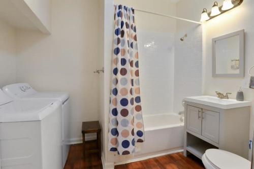 a bathroom with a sink and a shower curtain at Fabulous Franklin studio steps from St Claude Ave in New Orleans