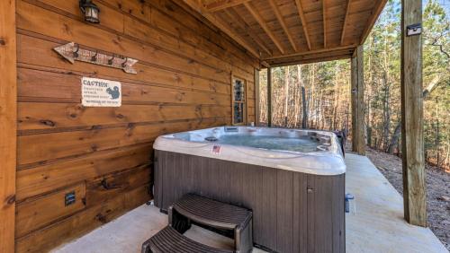 a large jacuzzi tub in a wooden cabin at Immeasurably More in Mineral Bluff