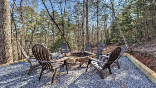 a group of chairs sitting around a fire pit at Immeasurably More in Mineral Bluff