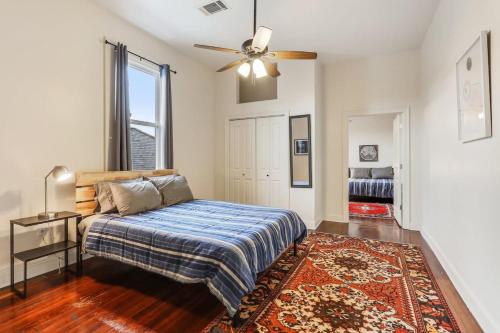 a bedroom with a bed and a window and a rug at Urban 3 bedroom Local Art Filled Frenchman Oasis in New Orleans