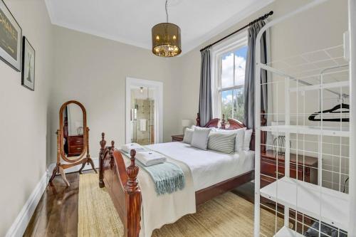 a bedroom with a bed and a window at Edwina Suite II - Fireplace, Elegant Heritage Home in Orange