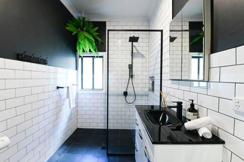 a bathroom with a sink and a shower at Sterling House Spacious Deck BBQ Pet Friendly in Dubbo