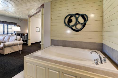 a large bath tub in a room with a bedroom at Stoney Creek Hotel Tulsa - Broken Arrow in Broken Arrow