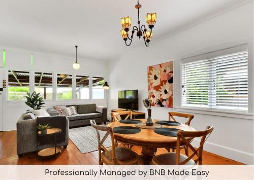 a living room with a table and a couch at Oasis on Warrendine, Sleek & Stylish, Free Wi-Fi in Orange