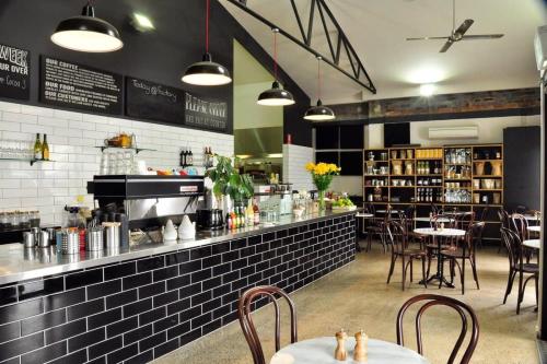 a restaurant with a counter and tables and chairs at Oasis on Warrendine, Sleek & Stylish, Free Wi-Fi in Orange