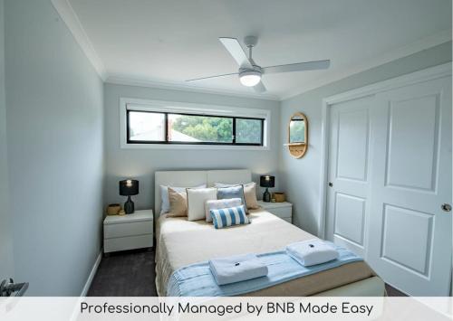 a bedroom with a bed with two towels on it at Cosy Retreat on Naman - Private & Convenient in Dubbo