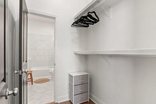 a bathroom with a closet with shoes on a shelf at Fabulous Classy and Comfy 3BD 2BA Home and Parking in New Orleans