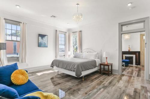 a bedroom with a bed and a blue couch at Spacious Mid City 1BD On The Canal Streetcar Line in New Orleans