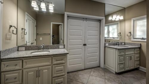 a bathroom with two sinks and a large mirror at Jump Right In in Blue Ridge